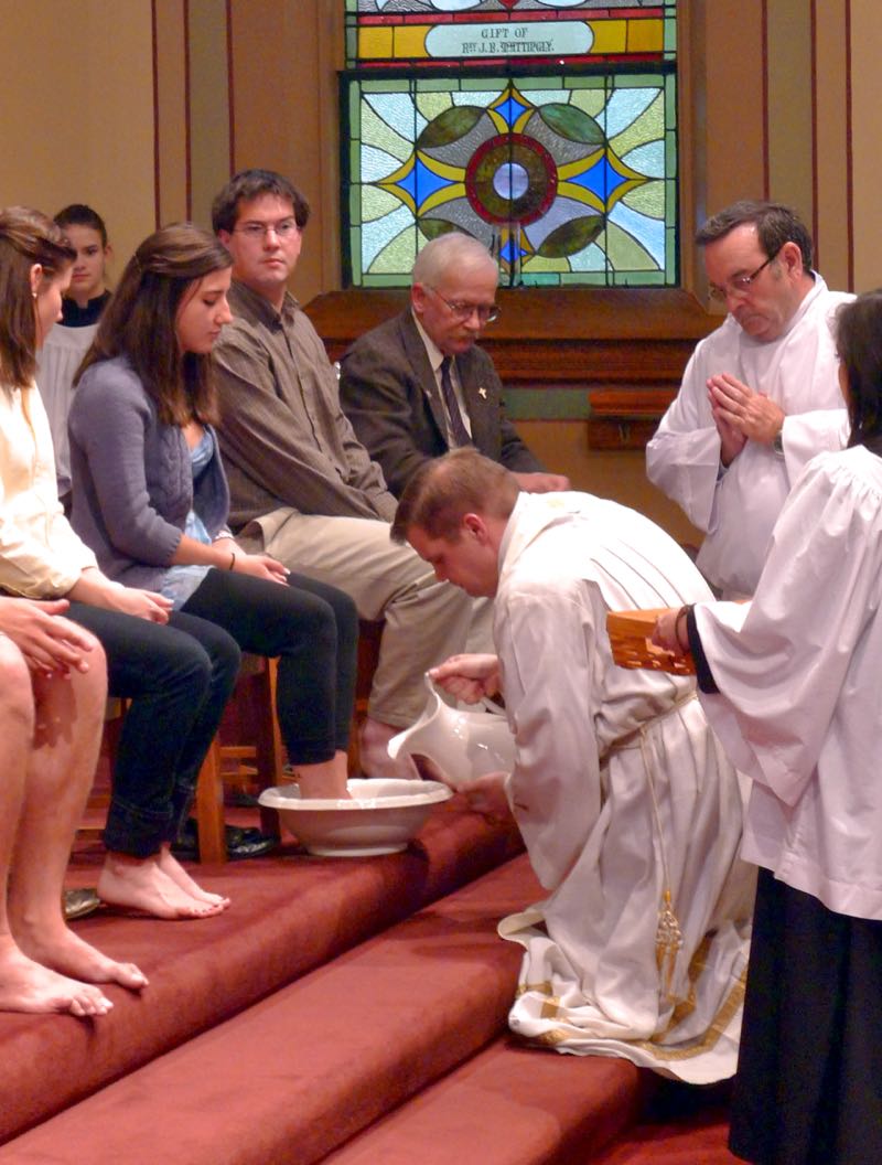 Maundy Thursday, 2012, as Father Mark washes the feet of the faithful. Standing next to him is Deacon Dan Murray, who died earlier this year.  (Credit: Dennis E. Powell)