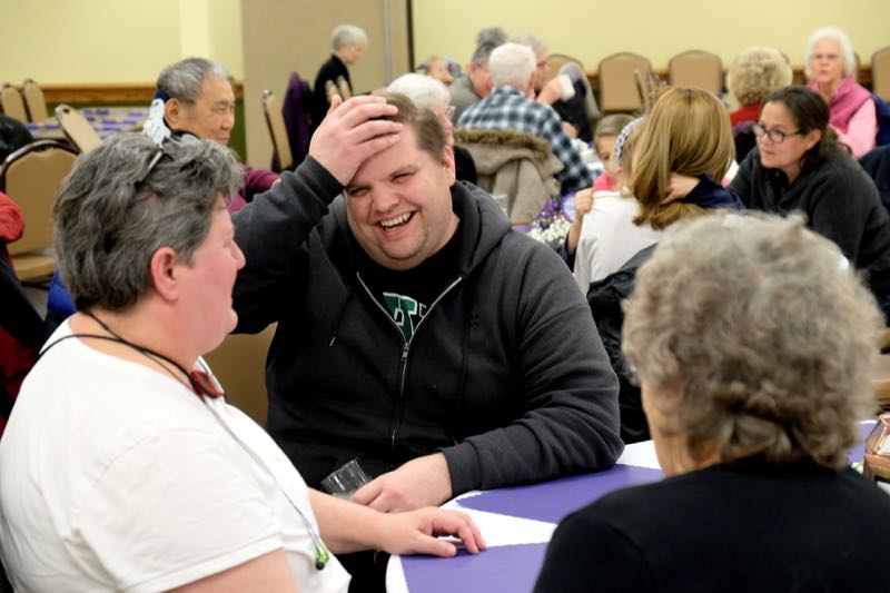 There is a fish fry every Friday during lent. Here a parishoner says something funny. (Credit: Dennis E. Powell)